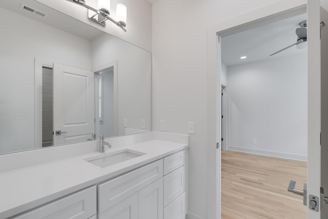 674B Westboro Dr, Nashville, TN 37209 - bathroom with vanity, wood finished floors, baseboards, and recessed lighting