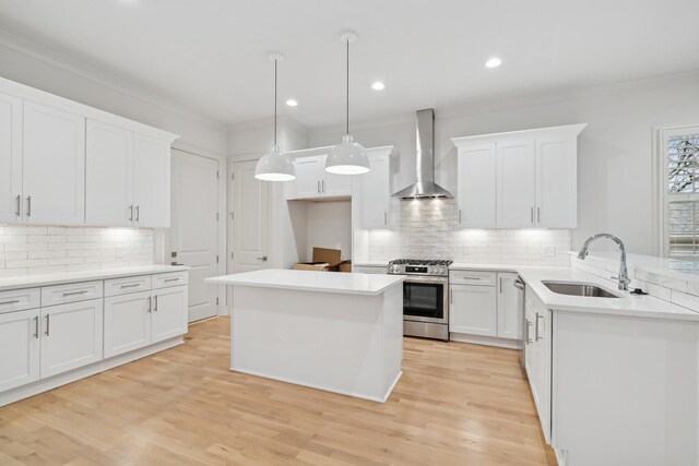 674B Westboro Dr, Nashville, TN 37209 - kitchen with appliances with stainless steel finishes, wall chimney range hood, a sink, backsplash, and white cabinetry
