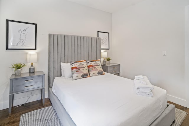 612 21st Ave N Unit 211, Nashville, TN 37203 - bedroom featuring baseboards and dark wood-style flooring