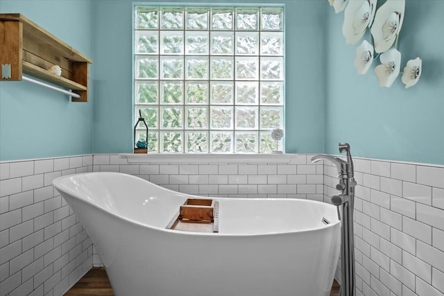 7244 Knottingham Dr, Fairview, TN 37062 - bathroom featuring tile walls, a freestanding bath, healthy amount of natural light, and wainscoting