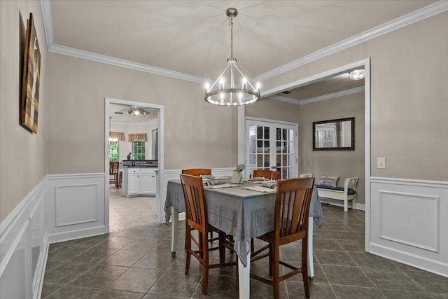 7244 Knottingham Dr, Fairview, TN 37062 - dining space with a decorative wall, wainscoting, crown molding, french doors, and dark tile patterned floors