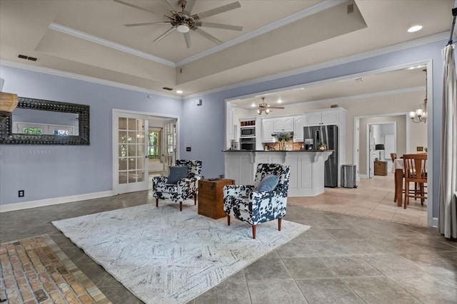 7244 Knottingham Dr, Fairview, TN 37062 - living room with a tray ceiling, ornamental molding, a ceiling fan, baseboards, and a chandelier