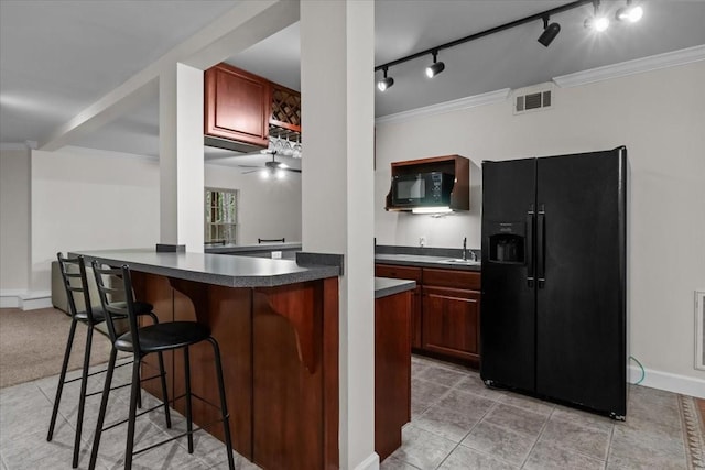 7244 Knottingham Dr, Fairview, TN 37062 - kitchen featuring black appliances, a sink, dark countertops, a breakfast bar, and crown molding