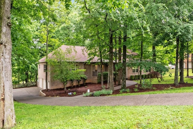 7244 Knottingham Dr, Fairview, TN 37062 - obstructed view of property with an attached garage, a front lawn, driveway, and stucco siding