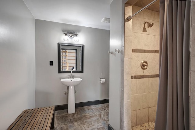 3155 Pigeon Spur Rd, Tracy City, TN 37387 - bathroom featuring tiled shower, baseboards, and a sink