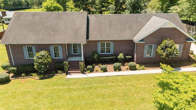 318 Tulip Tree Trl, Estill Springs, TN 37330 - view of front facade featuring a front yard, brick siding, and a shingled roof