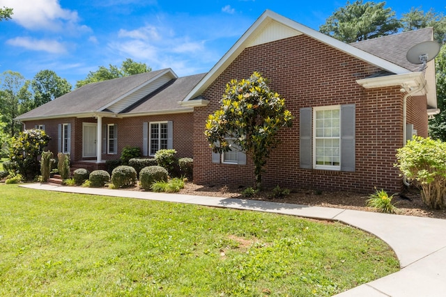 318 Tulip Tree Trl, Estill Springs, TN 37330 - view of front of property featuring brick siding, a front yard, and a shingled roof