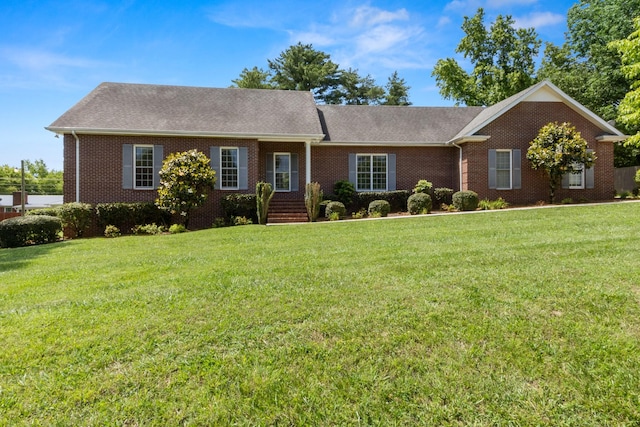 318 Tulip Tree Trl, Estill Springs, TN 37330 - ranch-style home featuring brick siding, a front yard, and roof with shingles