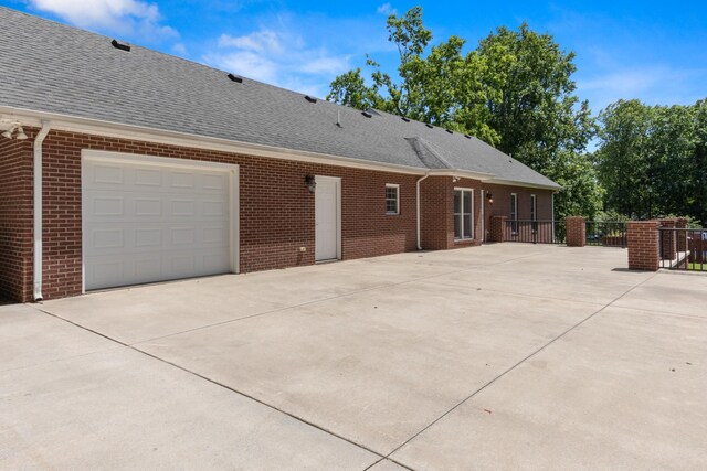 318 Tulip Tree Trl, Estill Springs, TN 37330 - view of side of home with driveway, brick siding, and a shingled roof