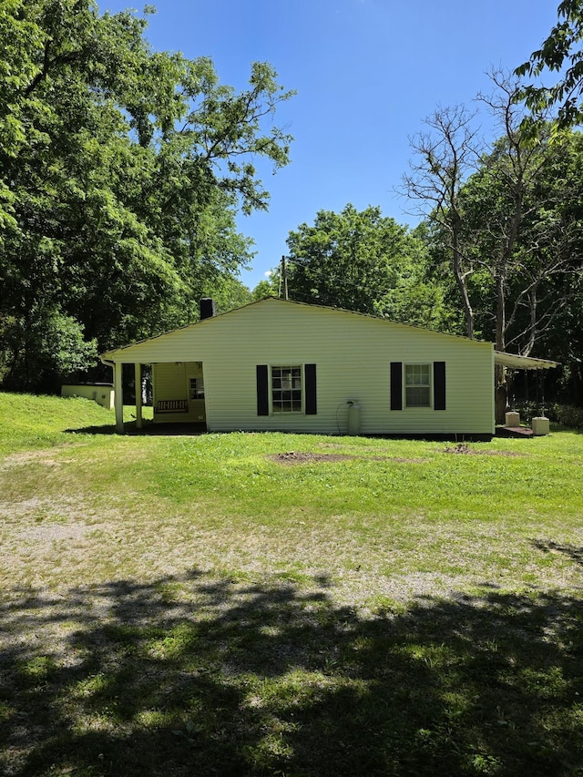 1048 Ross Hollow Rd, Ashland City, TN 37015 - rear view of property with a lawn and a chimney