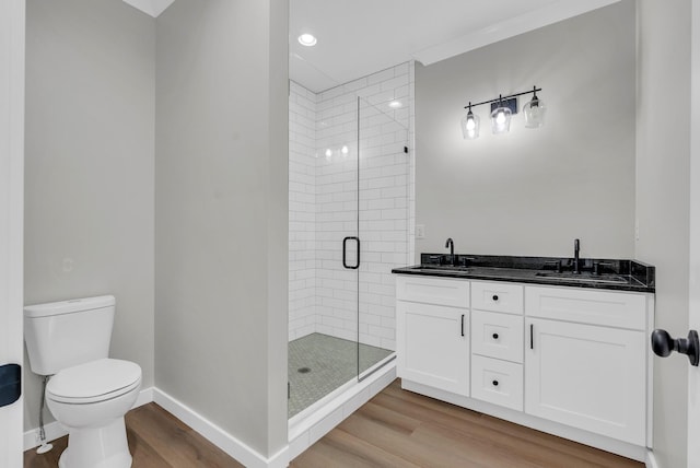 2600 Spring Arbor Ct, Cookeville, TN 38501 - bathroom featuring wood finished floors, a stall shower, toilet, double vanity, and baseboards
