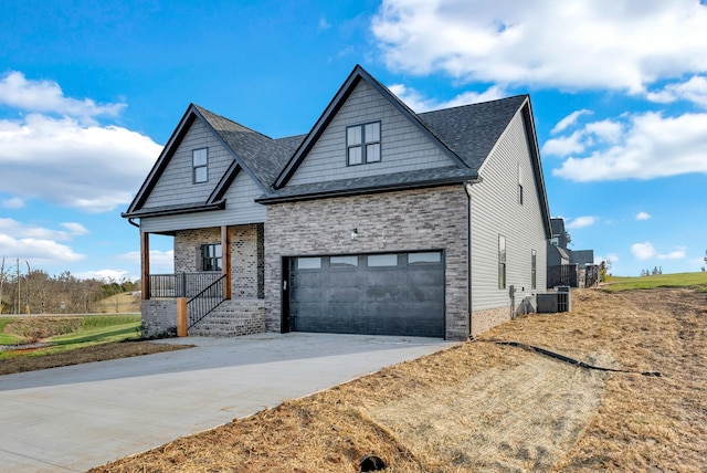 2600 Spring Arbor Ct, Cookeville, TN 38501 - view of front of home featuring concrete driveway, a porch, central air condition unit, a shingled roof, and a garage