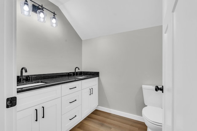 2600 Spring Arbor Ct, Cookeville, TN 38501 - bathroom with vaulted ceiling, toilet, baseboards, wood finished floors, and double vanity