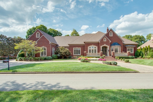 27 Governors Way, Brentwood, TN 37027 - view of front of home featuring brick siding, a front lawn, and a chimney