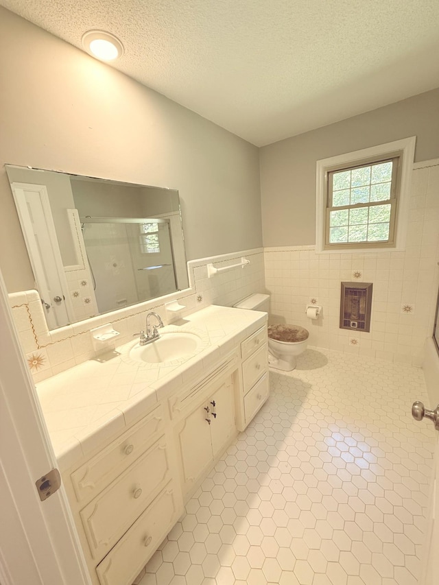 551 Maple Ter, Lafayette, TN 37083 - bathroom featuring tile patterned floors, tile walls, toilet, a shower with door, and vanity
