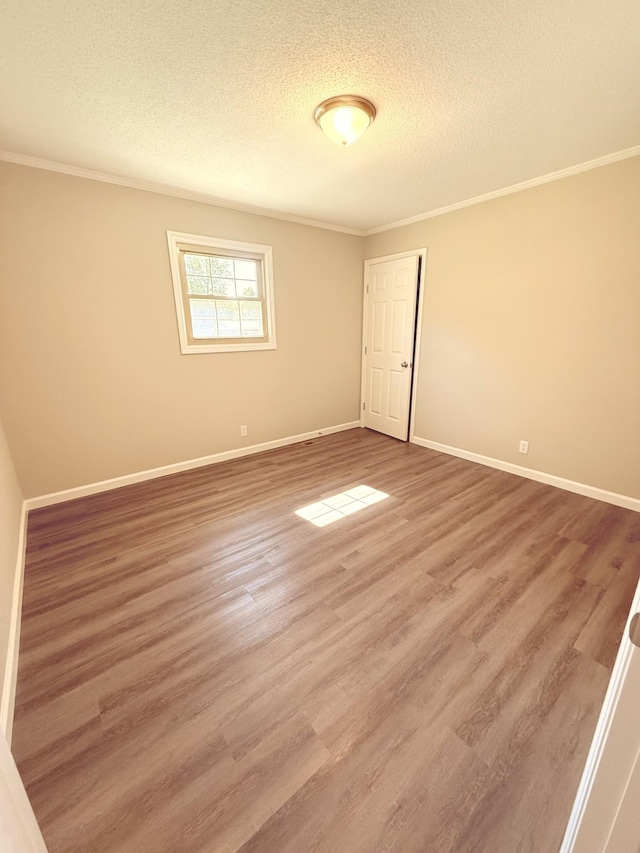 551 Maple Ter, Lafayette, TN 37083 - spare room with a textured ceiling, crown molding, baseboards, and wood finished floors