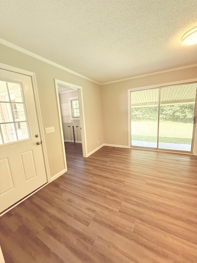 551 Maple Ter, Lafayette, TN 37083 - empty room featuring a textured ceiling, light wood-style flooring, crown molding, and baseboards