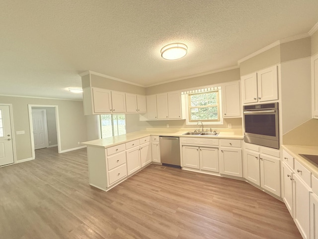 551 Maple Ter, Lafayette, TN 37083 - kitchen with appliances with stainless steel finishes, ornamental molding, a peninsula, a sink, and white cabinets