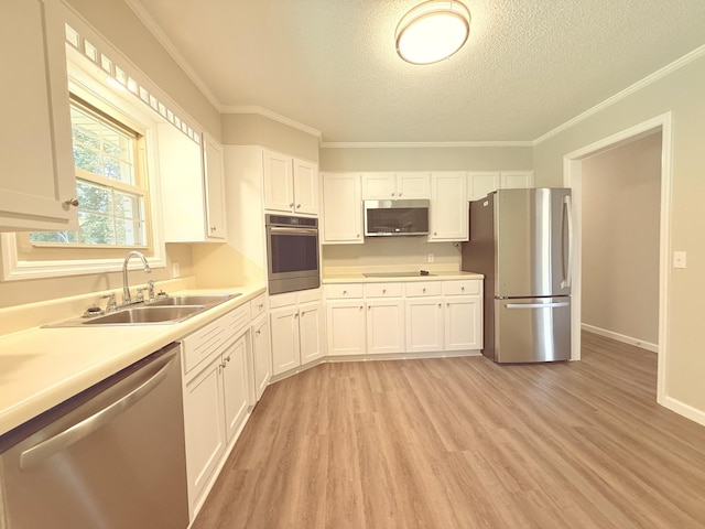 551 Maple Ter, Lafayette, TN 37083 - kitchen with stainless steel appliances, a sink, a textured ceiling, light countertops, and white cabinets