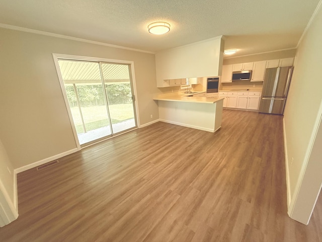 551 Maple Ter, Lafayette, TN 37083 - kitchen featuring appliances with stainless steel finishes, crown molding, baseboards, light countertops, and white cabinetry