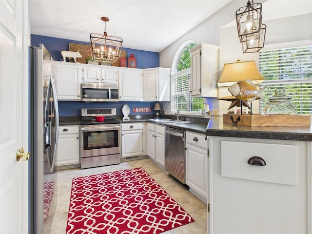 21 Heron Pt, Cadiz, KY 42211 - kitchen with stainless steel appliances, a chandelier, a sink, white cabinetry, and dark countertops