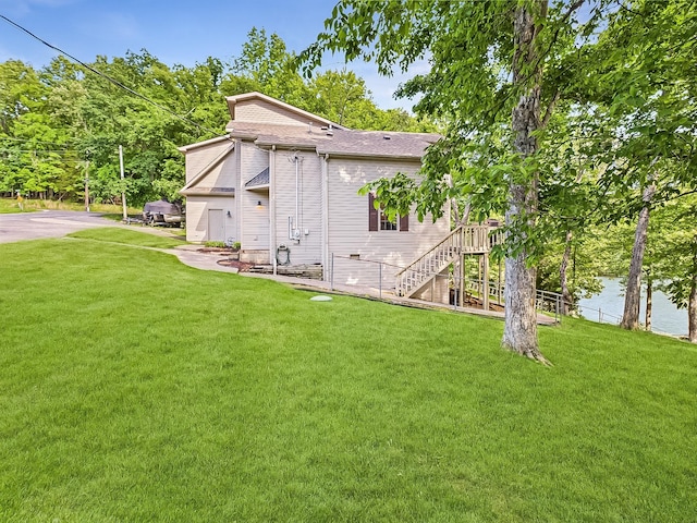 21 Heron Pt, Cadiz, KY 42211 - rear view of property with a lawn, stairs, roof with shingles, and a water view