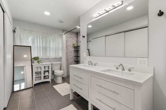 515 S Cedar Ln, Pulaski, TN 38478 - bathroom with toilet, double vanity, tiled shower, and recessed lighting