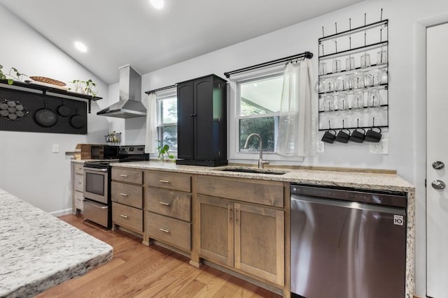 515 S Cedar Ln, Pulaski, TN 38478 - kitchen featuring stainless steel appliances, wall chimney exhaust hood, a sink, vaulted ceiling, and light wood-type flooring