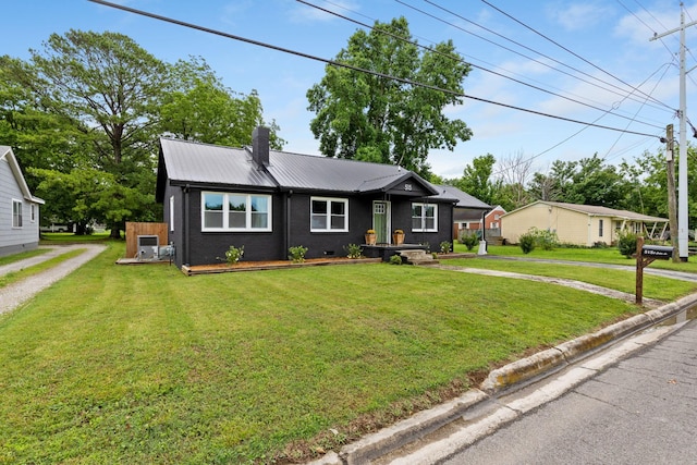 515 S Cedar Ln, Pulaski, TN 38478 - view of front of home with metal roof, a chimney, driveway, and a front lawn