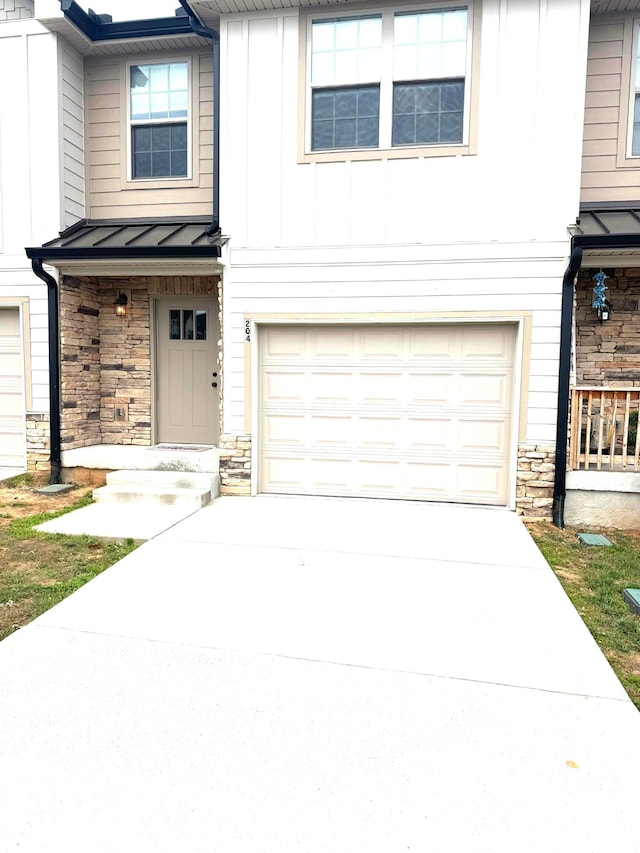 204 Signature Pl, Lebanon, TN 37087 - view of front of property with a standing seam roof, stone siding, a garage, board and batten siding, and driveway