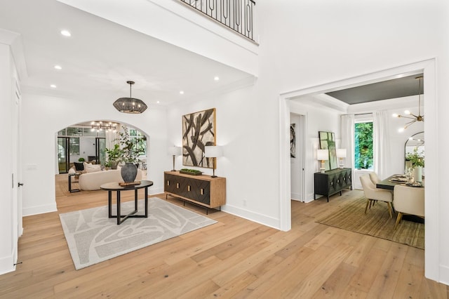 117 Alton Rd, Nashville, TN 37205 - foyer entrance featuring a chandelier, arched walkways, light wood finished floors, recessed lighting, and baseboards
