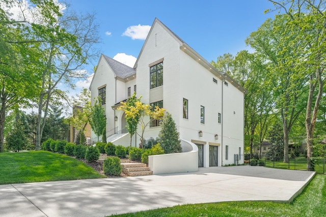 117 Alton Rd, Nashville, TN 37205 - view of side of property featuring stucco siding, driveway, and a garage