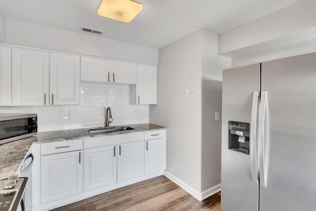 5839 Brentwood Trce, Brentwood, TN 37027 - kitchen featuring appliances with stainless steel finishes, a sink, wood finished floors, baseboards, and light stone counters