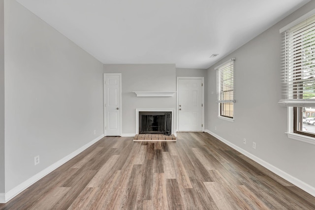 5839 Brentwood Trce, Brentwood, TN 37027 - unfurnished living room featuring wood finished floors, a fireplace with raised hearth, and baseboards