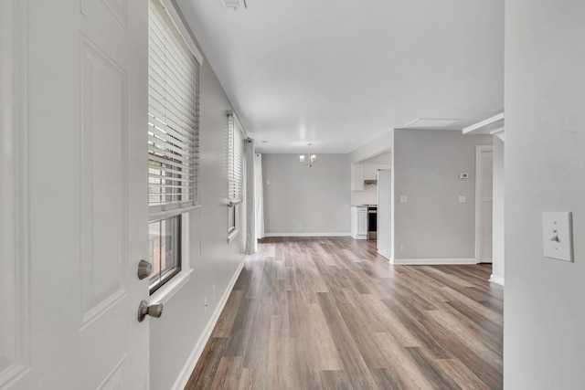 5839 Brentwood Trce, Brentwood, TN 37027 - unfurnished living room featuring wood finished floors, baseboards, and a chandelier