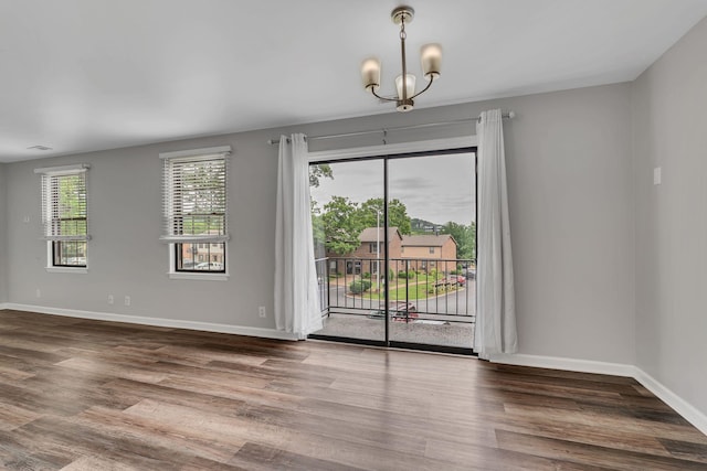 5839 Brentwood Trce, Brentwood, TN 37027 - unfurnished dining area featuring a chandelier, wood finished floors, and baseboards
