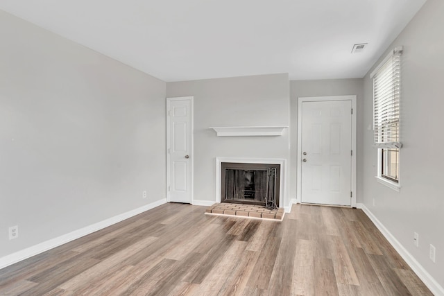 5839 Brentwood Trce, Brentwood, TN 37027 - unfurnished living room featuring wood finished floors, a fireplace with raised hearth, and baseboards