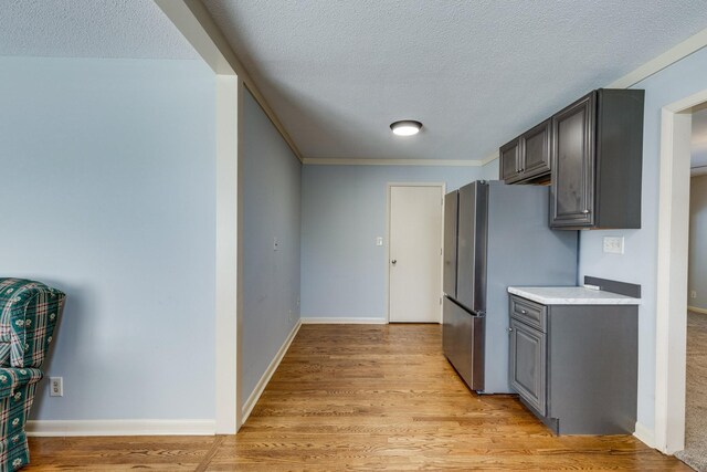2023 Denise Dr, Columbia, TN 38401 - kitchen featuring freestanding refrigerator, a textured ceiling, light countertops, light wood-type flooring, and gray cabinets