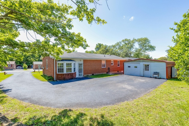 2023 Denise Dr, Columbia, TN 38401 - single story home featuring an outbuilding, brick siding, asphalt driveway, a detached garage, and a front yard