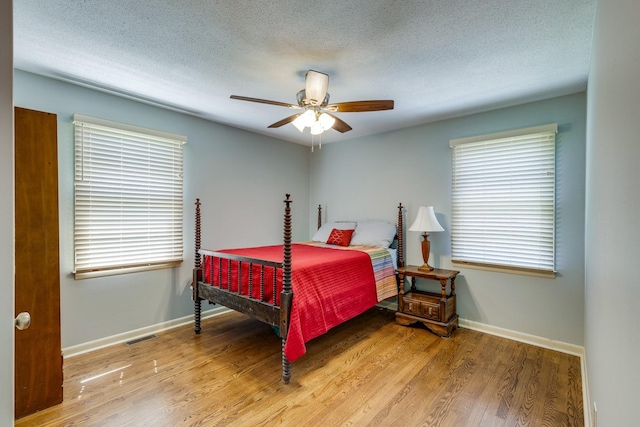 2023 Denise Dr, Columbia, TN 38401 - bedroom featuring wood finished floors, multiple windows, baseboards, and a textured ceiling