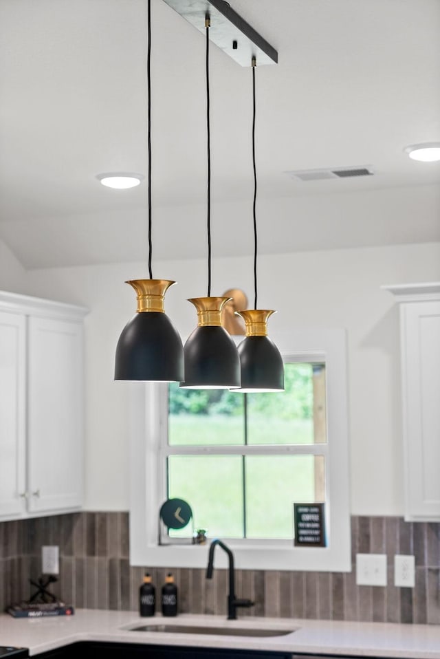 201 Dewberry Ct, Clarksville, TN 37042 - kitchen with a sink, white cabinets, backsplash, and light countertops