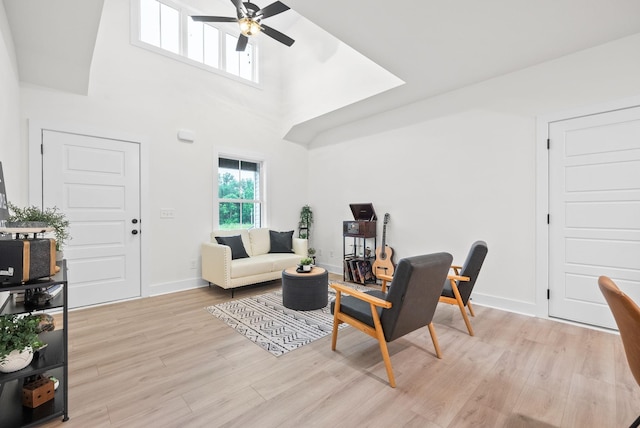 185 Dewberry Ct, Clarksville, TN 37042 - living area featuring a ceiling fan, light wood-style flooring, a towering ceiling, and baseboards