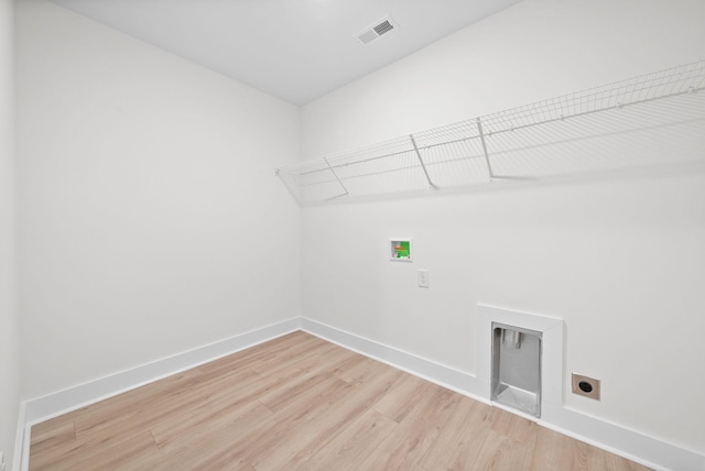 185 Dewberry Ct, Clarksville, TN 37042 - laundry room with electric dryer hookup, hookup for a washing machine, light wood-type flooring, and baseboards