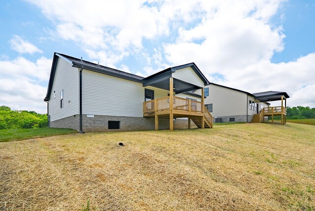 185 Dewberry Ct, Clarksville, TN 37042 - rear view of property featuring stairs, crawl space, a wooden deck, and a lawn