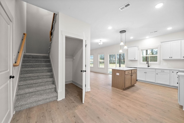 193 Dewberry Ct, Clarksville, TN 37042 - kitchen featuring a sink, a kitchen island, recessed lighting, light countertops, and white cabinets
