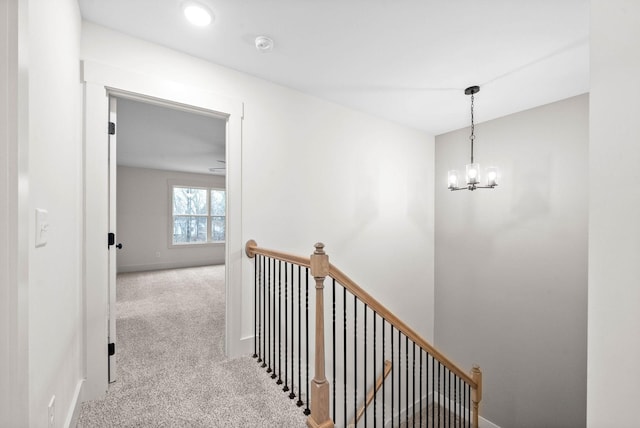 193 Dewberry Ct, Clarksville, TN 37042 - hall with an upstairs landing, carpet flooring, a chandelier, and baseboards
