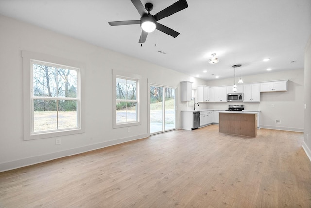 193 Dewberry Ct, Clarksville, TN 37042 - kitchen with appliances with stainless steel finishes, open floor plan, light countertops, a kitchen island, and baseboards