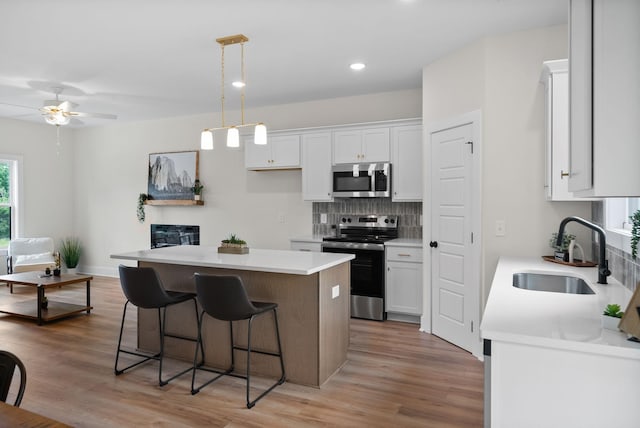 197 Dewberry Ct, Clarksville, TN 37042 - kitchen featuring stainless steel appliances, a sink, white cabinetry, backsplash, and recessed lighting