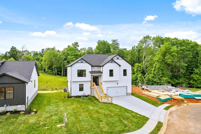 197 Dewberry Ct, Clarksville, TN 37042 - modern farmhouse featuring an attached garage, driveway, a front yard, and central AC unit