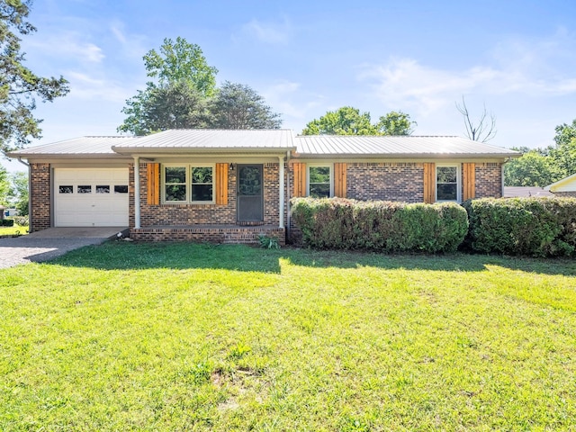 103 Cedar St, Huntland, TN 37345 - single story home featuring an attached garage, brick siding, driveway, and a front yard